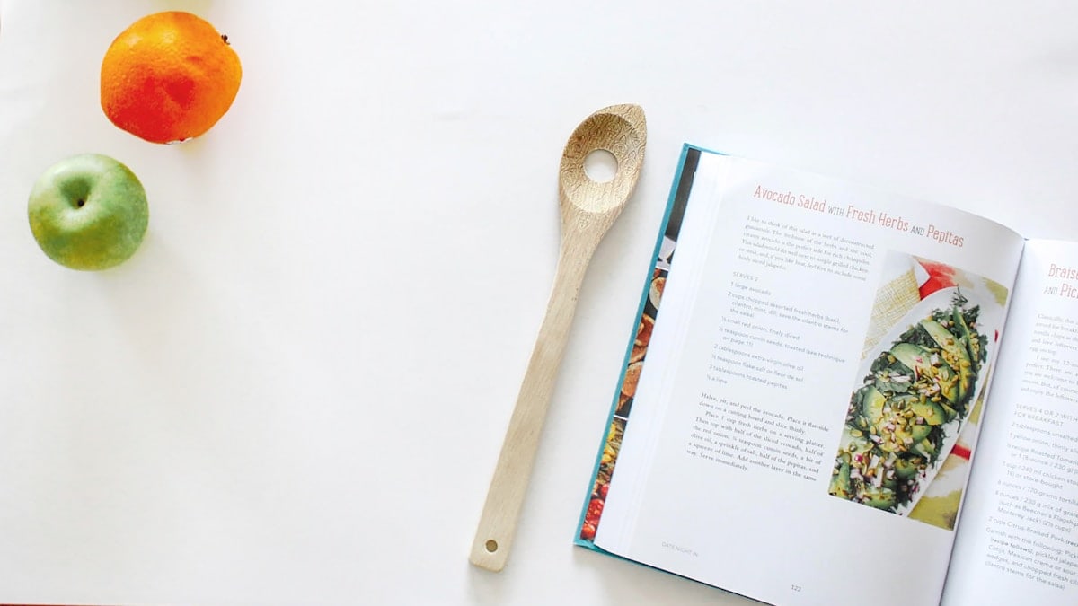 brown wooden spoon and book